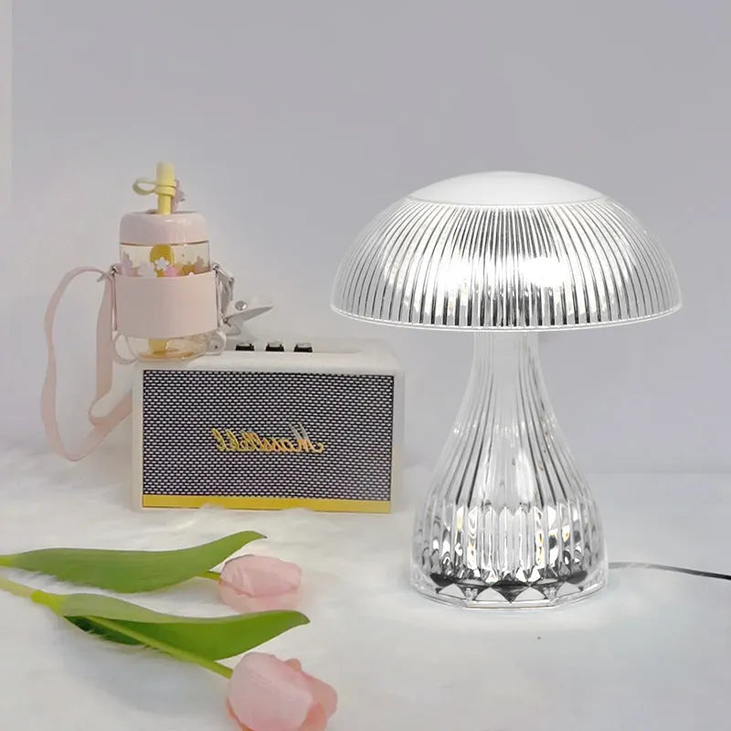USB rechargeable acrylic table lamp with three colour changing modes on a surface.