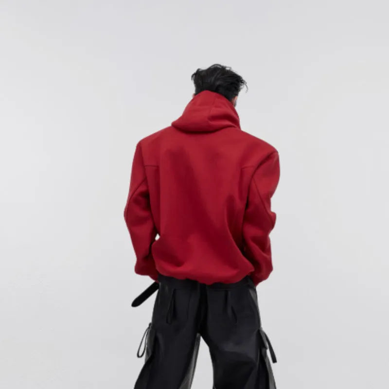 Men's red hooded sweater with heavy shoulder pads and raised metal printing details on front