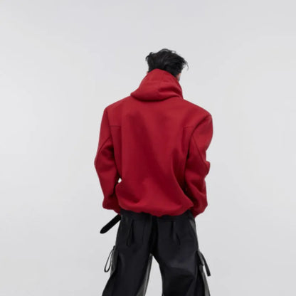 Men's red hooded sweater with heavy shoulder pads and raised metal printing details on front