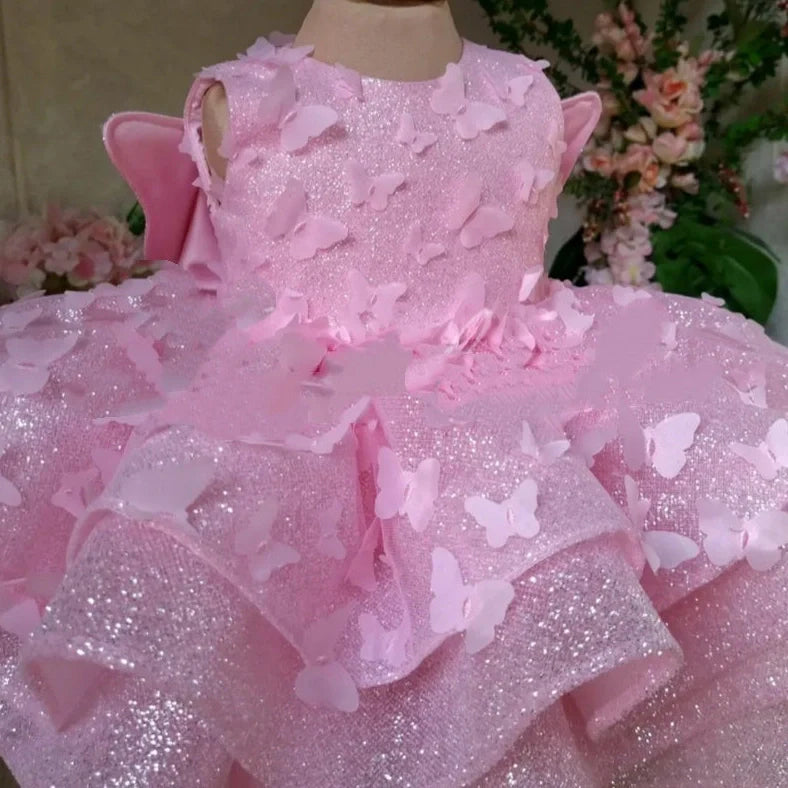 Pink sleeveless girls' dress with three-dimensional butterfly decoration on front