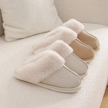 Women's plush indoor slippers in a selection of colours with a fuzzy upper and flat sole.