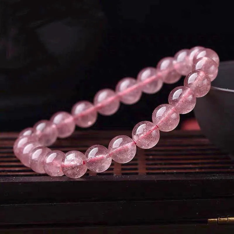 Women's strawberry quartz crystal bracelet with mixed 6mm, 8mm, and 10mm polished beads.