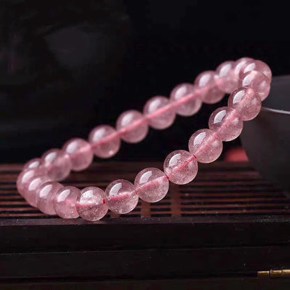 Women's strawberry quartz crystal bracelet with mixed 6mm, 8mm, and 10mm polished beads.