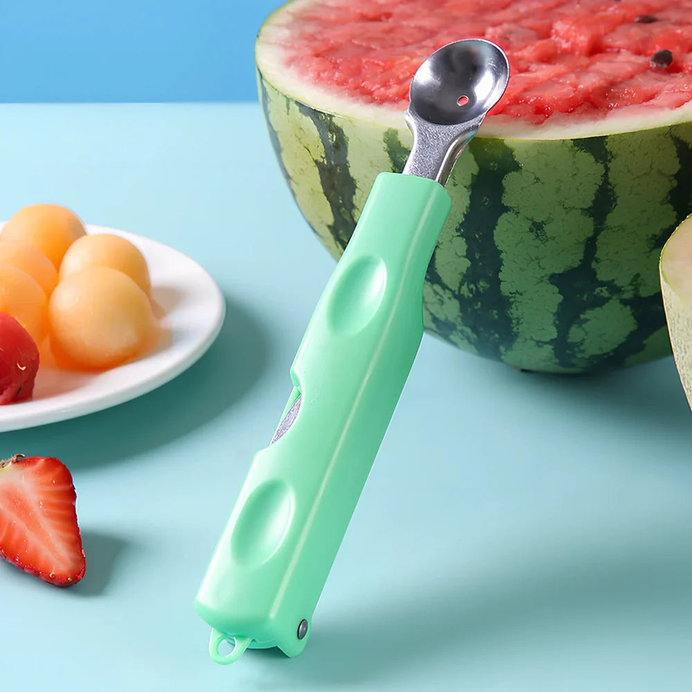 Three-in-one stainless steel watermelon ball digger in grass green, 24cm long with hidden knife and 10cm scoop for fruit slicing