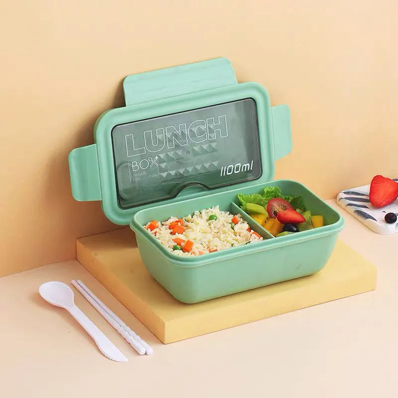 Green four-compartment plastic bento box with secure lid, showing internal partitions for separate food storage.