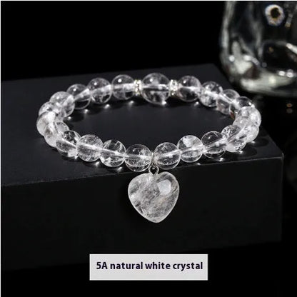 Handmade women's bracelet with natural gemstone beads and a silver love pendant charm.