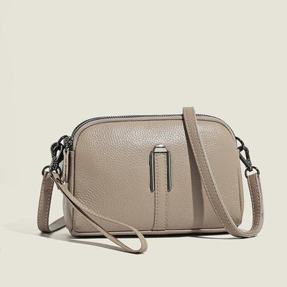 Women's genuine leather square shoulder bag in black, shown from front, displaying structured horizontal shape.