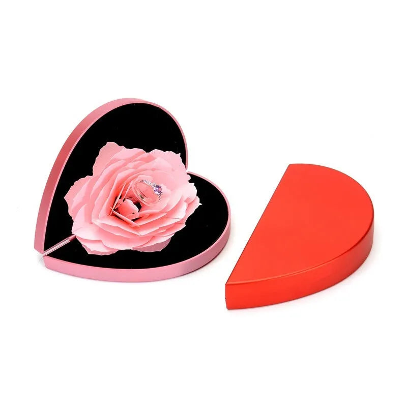 Red 3D heart-shaped plastic ring box with rose decoration on a rotating stand