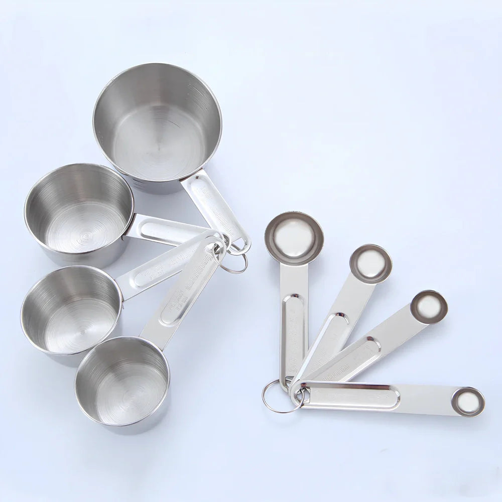 Stainless steel measuring spoons and cups set with engraved markings and removable storage rings