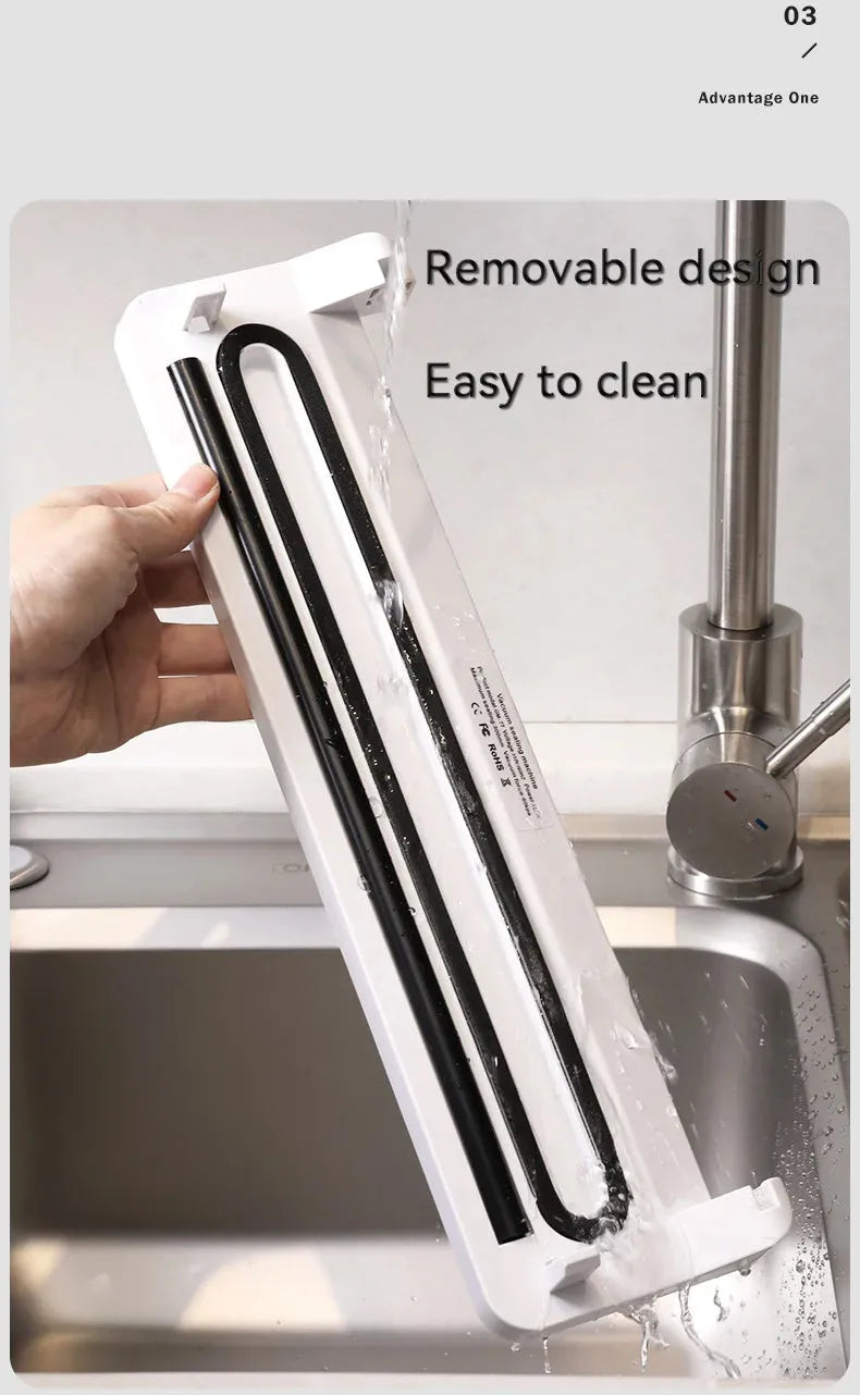White automatic vacuum sealer on a kitchen counter, showing compact design with one-touch button for food preservation.