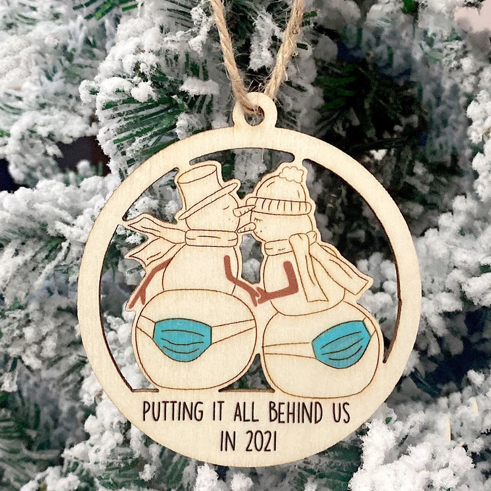 Wooden hollowed-out Christmas ornament with intricate snowman and deer laser-cut design