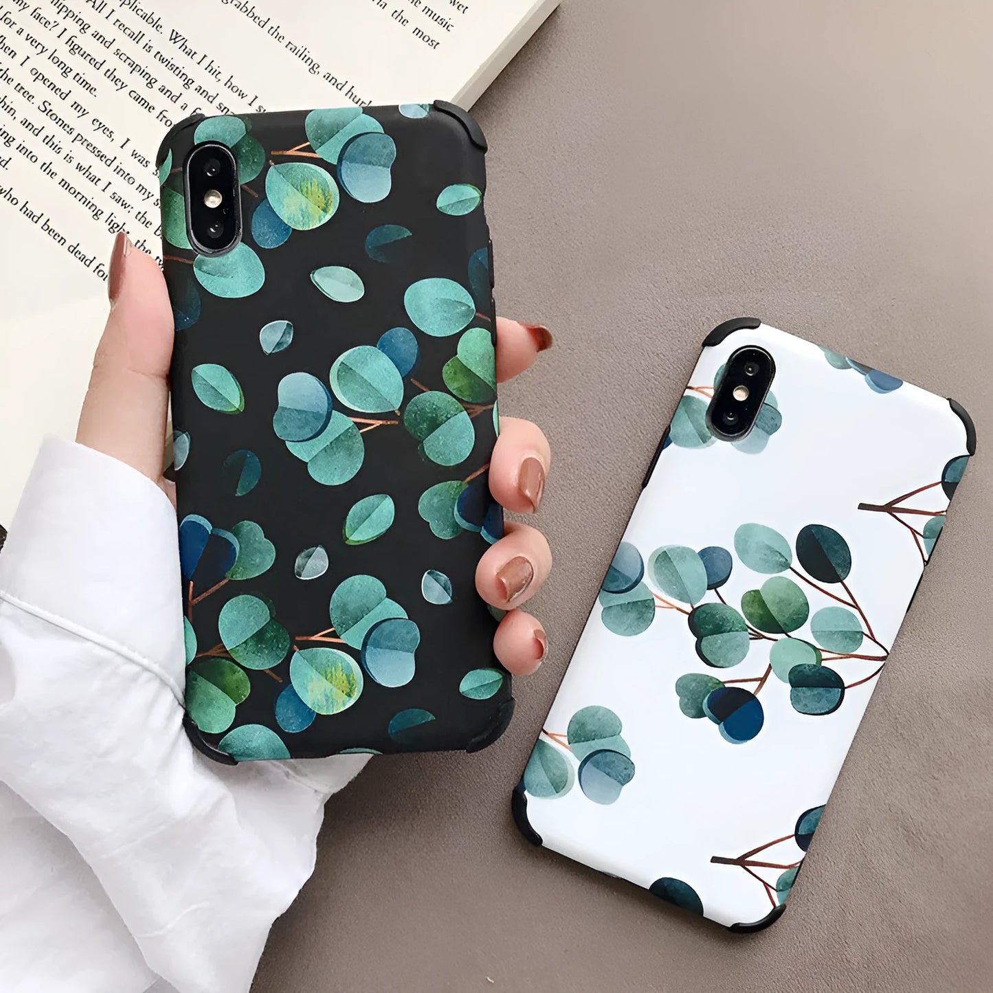 Black silicone iPhone case with a leaf pattern design on the back.