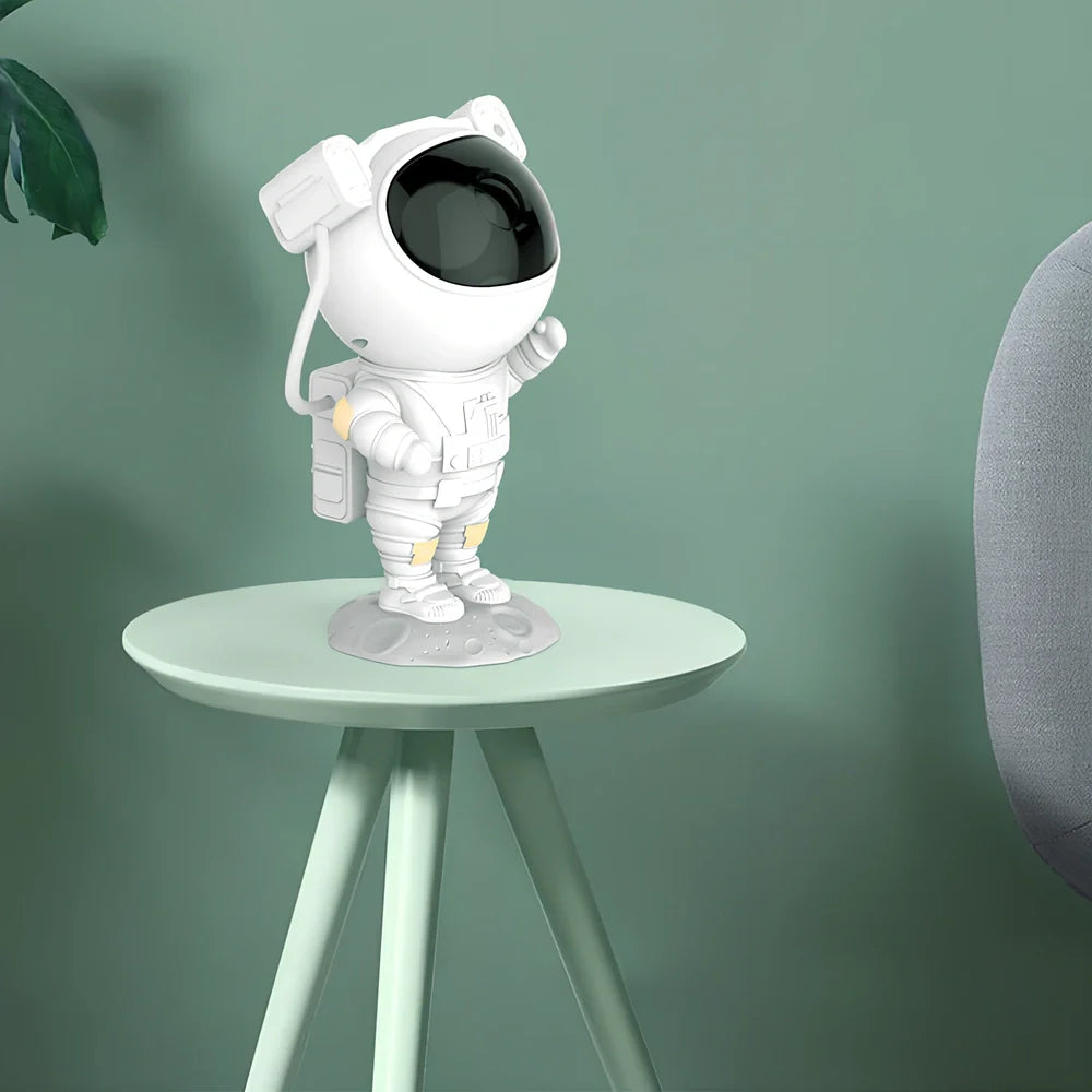 White astronaut-shaped night light projecting star patterns on ceiling with remote control