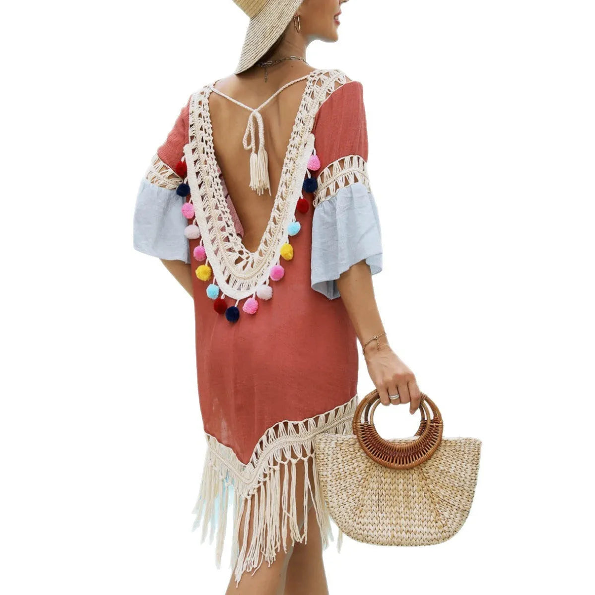 Orange floral pattern beach overskirt with white crochet stitching and long tassels.