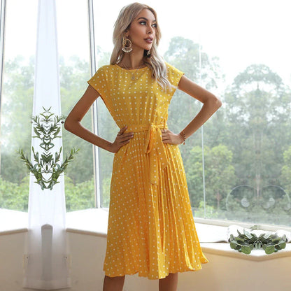 Elegant polka dot midi dress with short sleeves, made of soft viscose fabric and featuring a flattering pleated A-line skirt