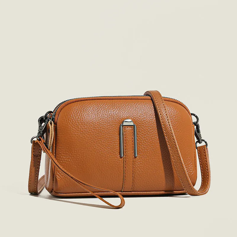 Women's genuine leather square shoulder bag in black, shown from front, displaying structured horizontal shape.