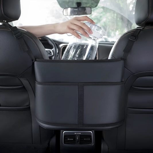 Black leather car seat gap storage bag with carbon fibre pattern, shown between car seats.