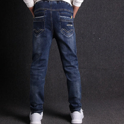 Boys' black micro-stretch cotton jeans showing 4-way flexibility and middle waist design