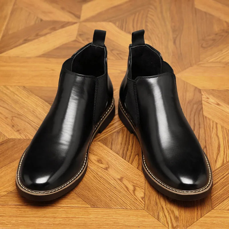 Black and brown formal pointed-toe leather boots with a square heel on a rubber sole.