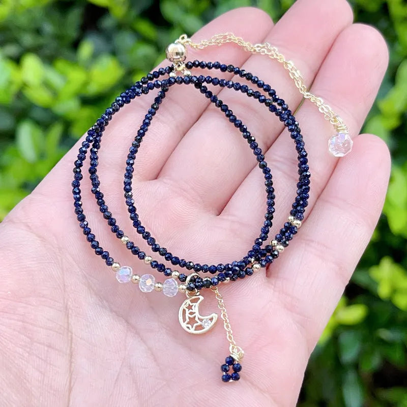 Blue gold sand stone cut three-ring multi-layer bracelet for women on a wrist.