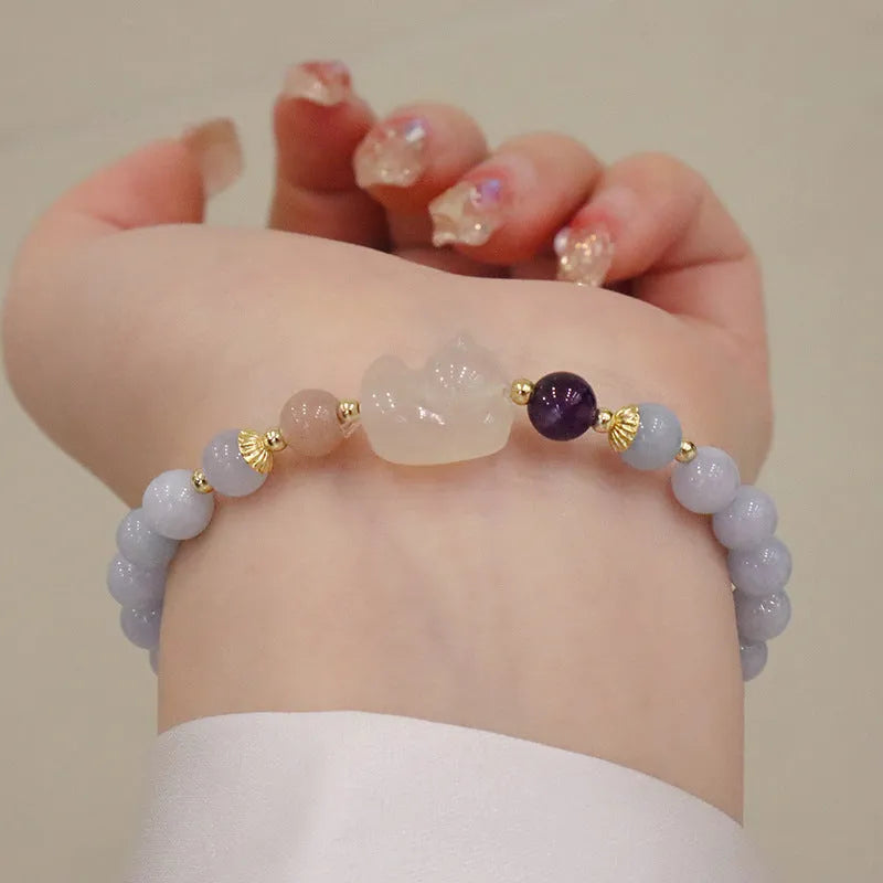 Gold plated women's bracelet with artificial crystal aquamarine chalcedony pendant in climbing cat design