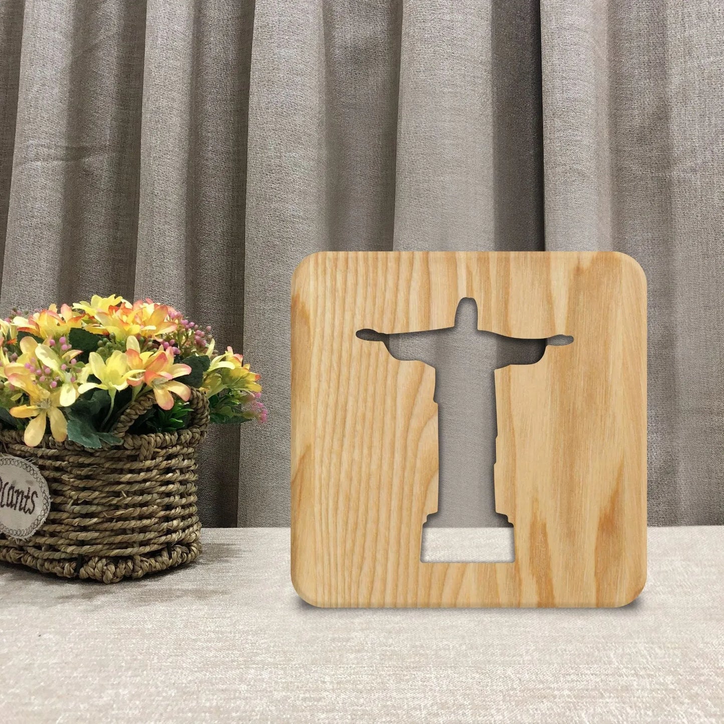 Solid wood hollow night lamp with warm white LED light on a surface