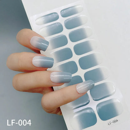 Sheet of 16 small design nail art stickers including cross, rose, tulip and marble patterns.