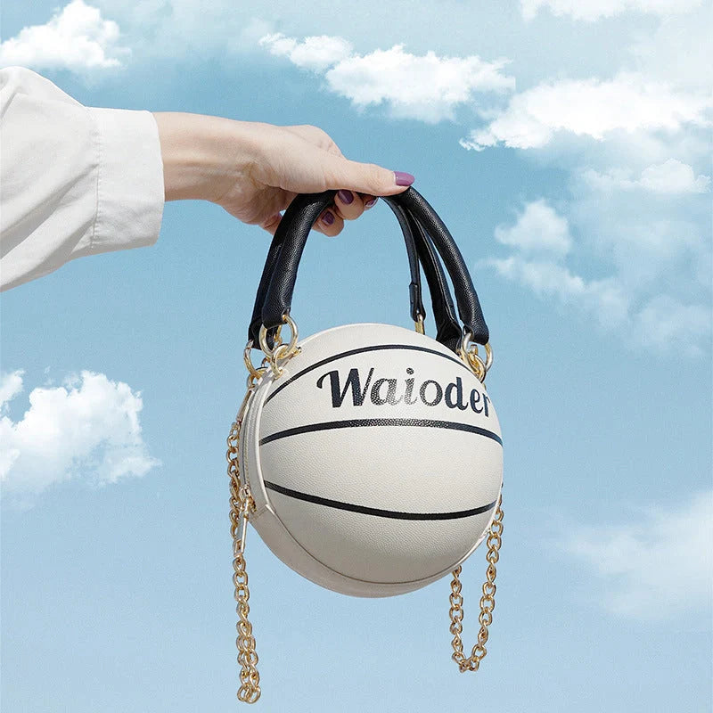 Basketball-shaped handbag with adjustable shoulder strap in pink, white, black, and brown