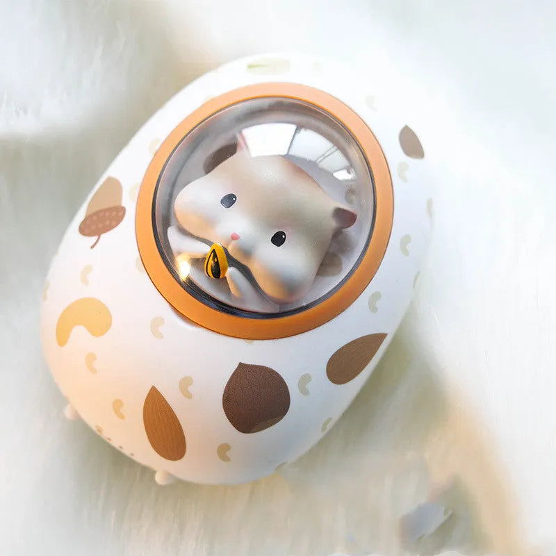White Hamster hand warmer and power bank unit with 5000mAh capacity on a plain background.