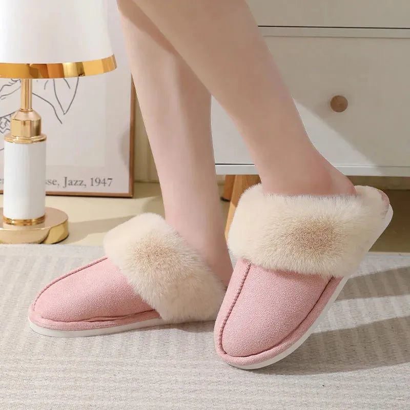 Women's plush indoor slippers in a selection of colours with a fuzzy upper and flat sole.