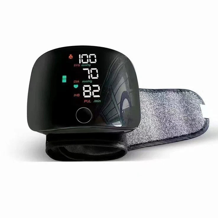 Black wrist blood pressure monitor with USB charging port and multilingual voice guidance options