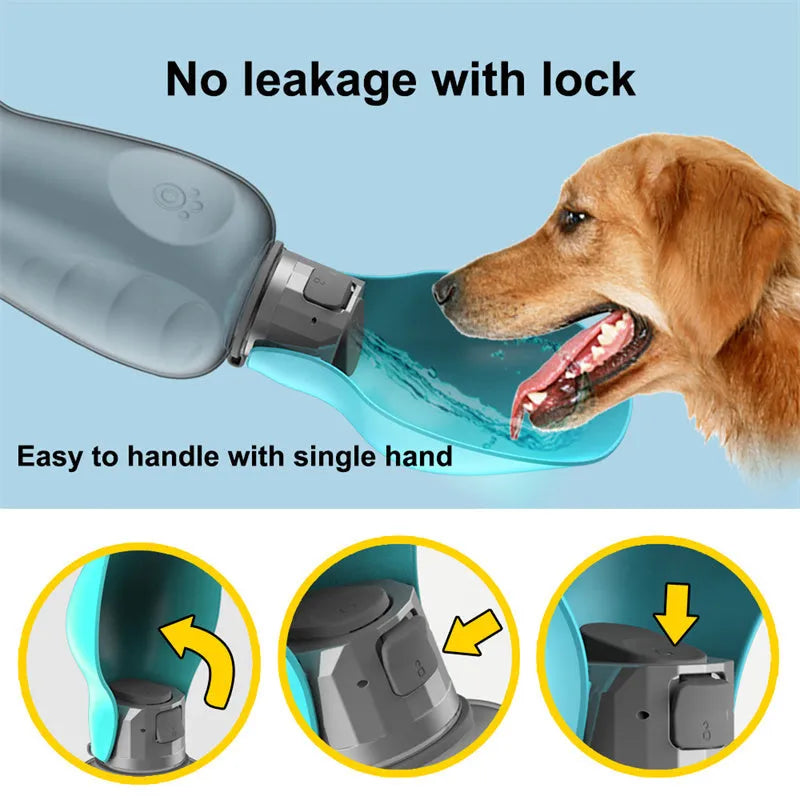 Blue grey portable dog water bottle with foldable drinking bowl and wrist strap, shown next to a dog.
