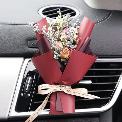 Mini dried flower bouquet mounted in car air vent for decorative aromatherapy