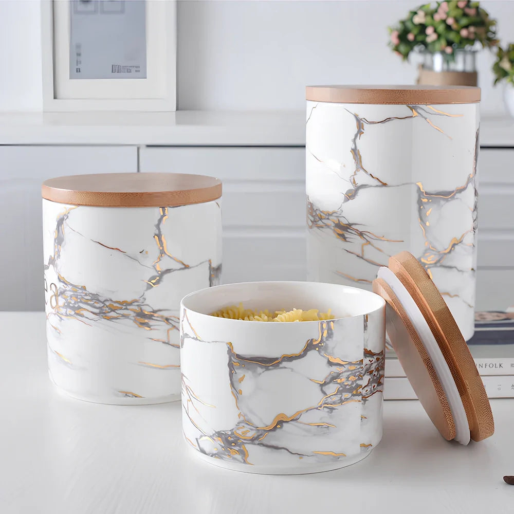 Three marbled ceramic storage jars with wooden lids showing large, medium, and small sizes