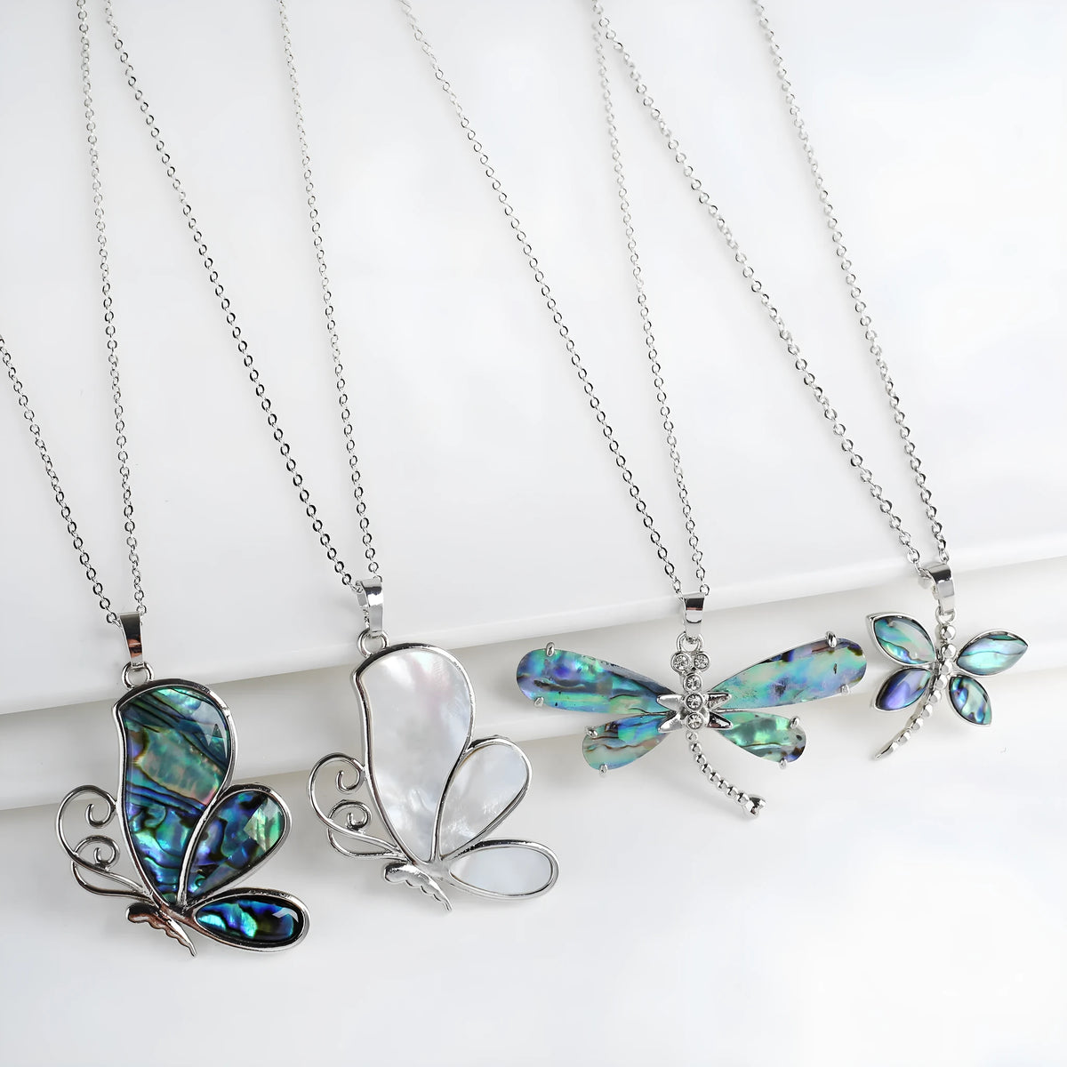 Abalone shell pendant necklace with copper electroplated animal zodiac design and butterfly or dragonfly detail