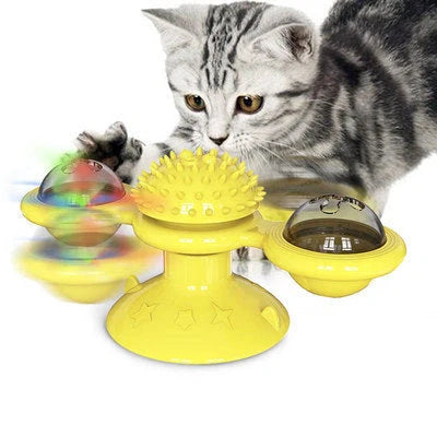 Cat playing with rotating windmill toy featuring suction base and luminous ball