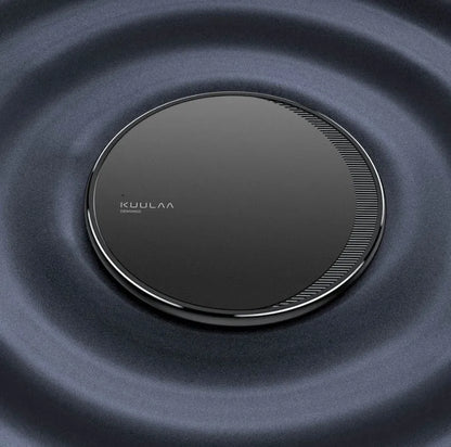 Black Kuulaa KL-CD16 wireless disc charger for mobile phones on a surface.