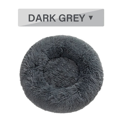Fluffy donut-shaped dog bed in dark grey colour with raised edges, showing plush texture and circular design