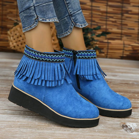 Women's thick bottom wedge bootie in suede with side zipper and tassel detail, available in multiple colours.