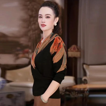 Black geometric floral pattern V-neck sweater with long sleeves and loose fit on hanger