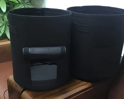 Black plant growth bag with side harvesting window and double handles for potato gardening