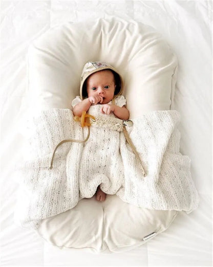 Beige portable cotton baby nest crib measuring 75 by 45 centimetres for newborn infants