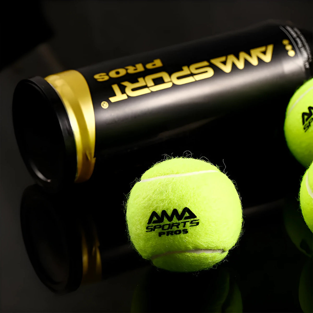 Three tennis training balls in black, green and yellow colours for cage plate practice