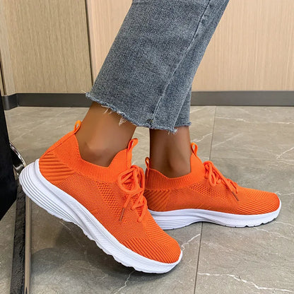 Women's low-top mesh Flyknit tennis shoes in creamy white, with a rubber sole and round toe.