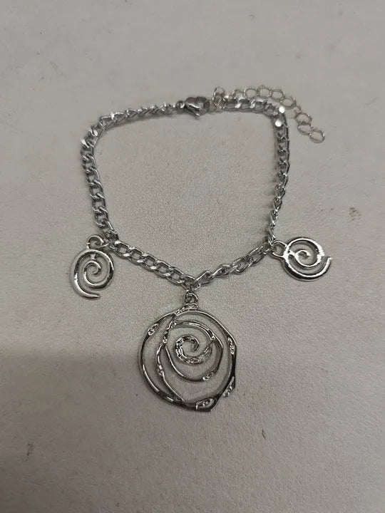 Gold spiral donut alloy jewellery set showing necklace, bracelet, and ear hooks on a plain background.