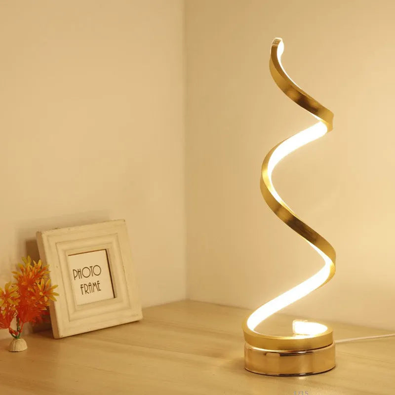 Black and white minimalist LED bedside lamp with aluminium shade and tri-colour dimming on a table