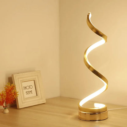 Black and white minimalist LED bedside lamp with aluminium shade and tri-colour dimming on a table