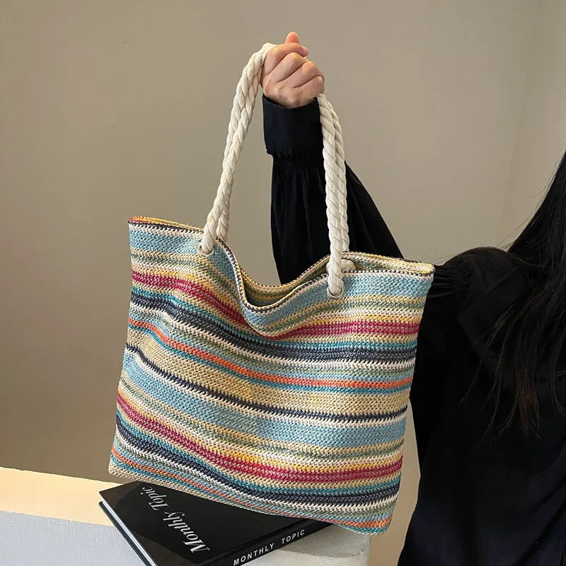 Blue straw-woven nylon shoulder bag with a single strap and large compartment.