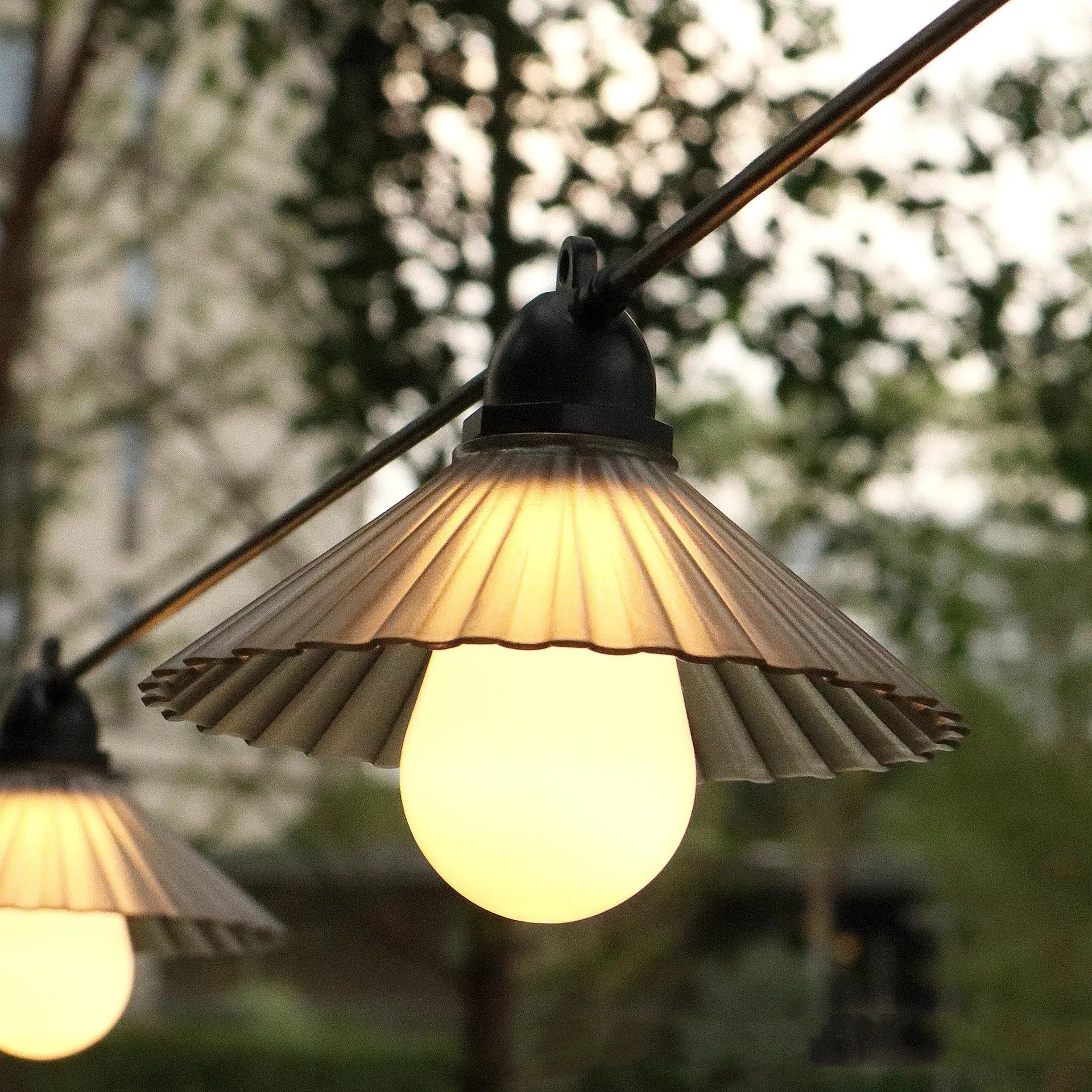 Outdoor LED string lights with flower-shaped bulbs in warm white or multicolour options