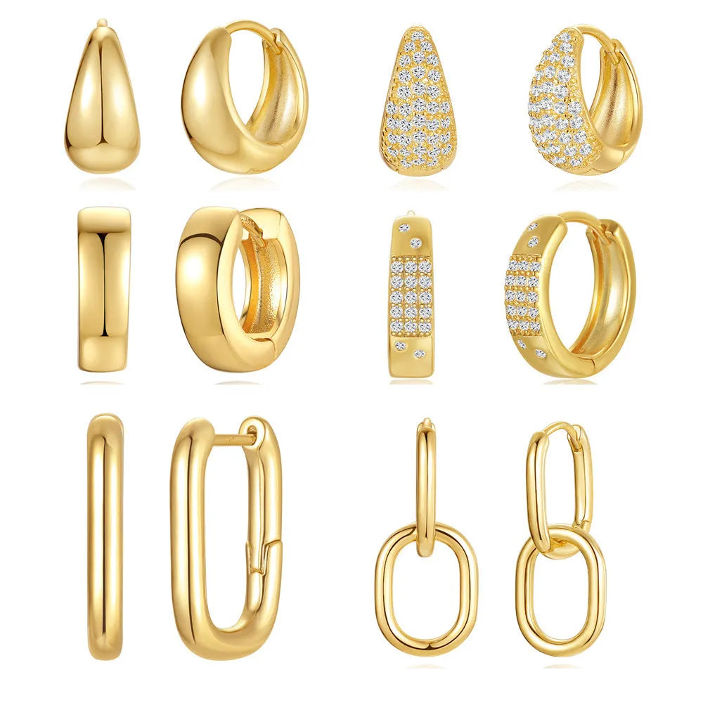 A pair of golden geometric clip-on earrings with a round design element on a white background.